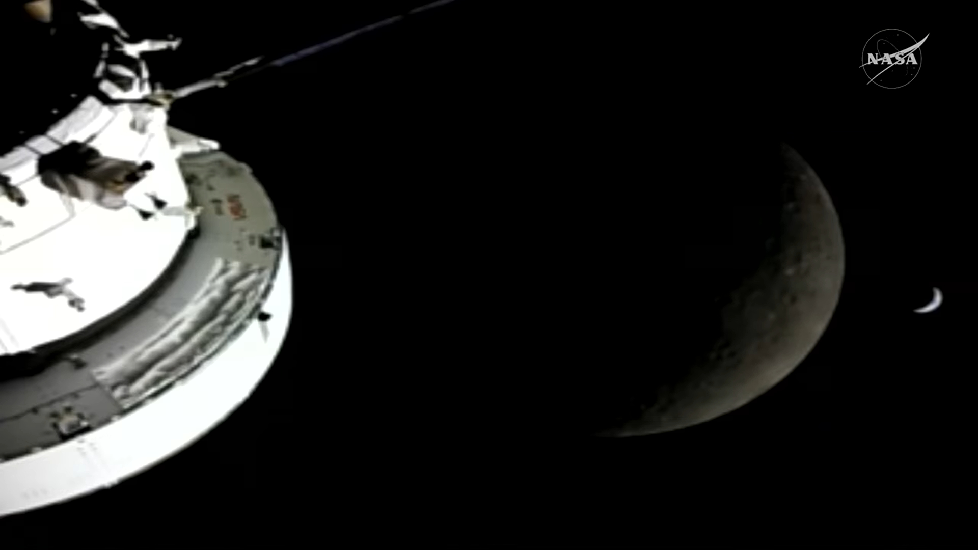 Artemis 2 beyond the moon with crescent Earth.