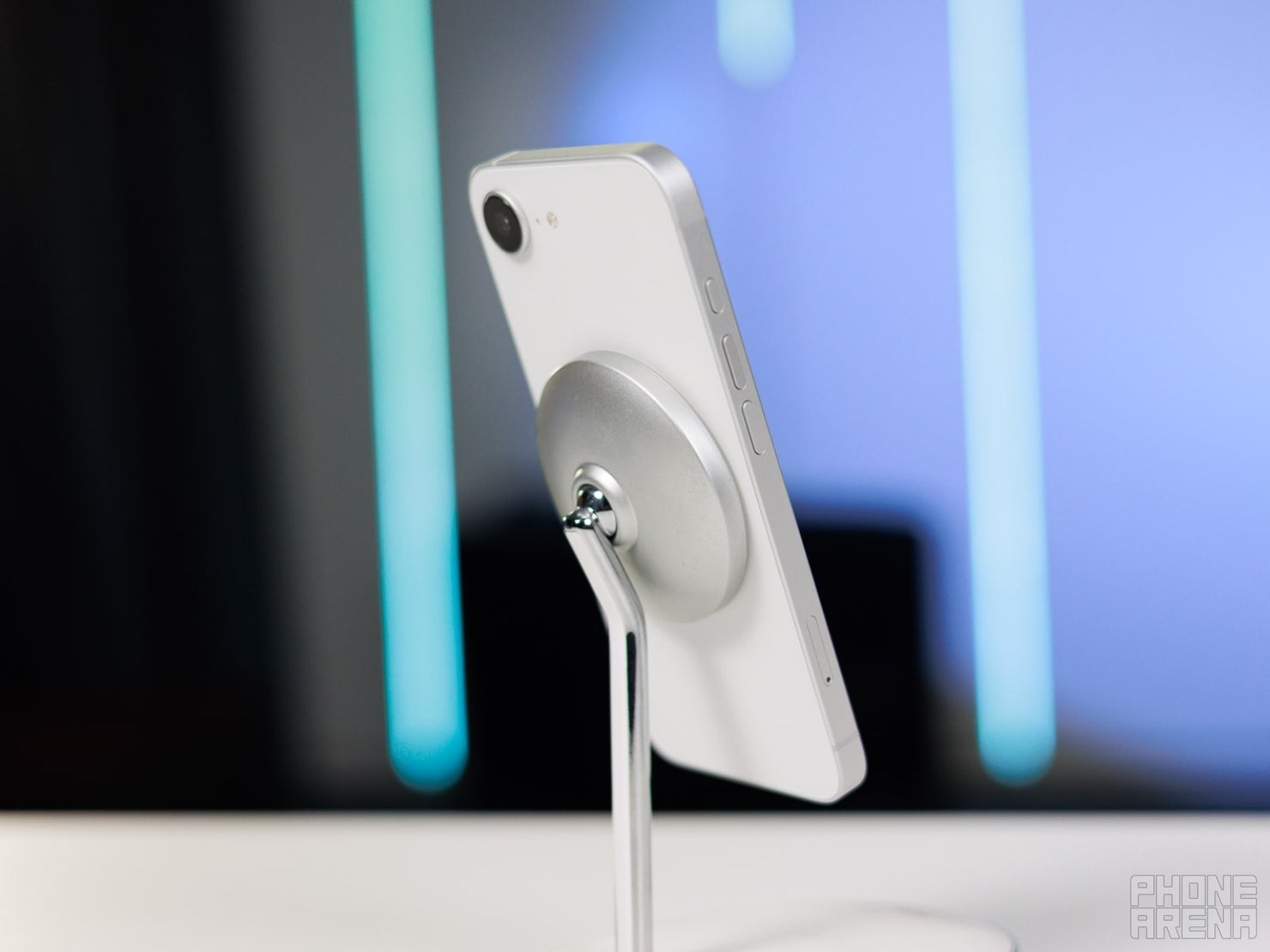 White iPhone 17e charging on MagSafe stand