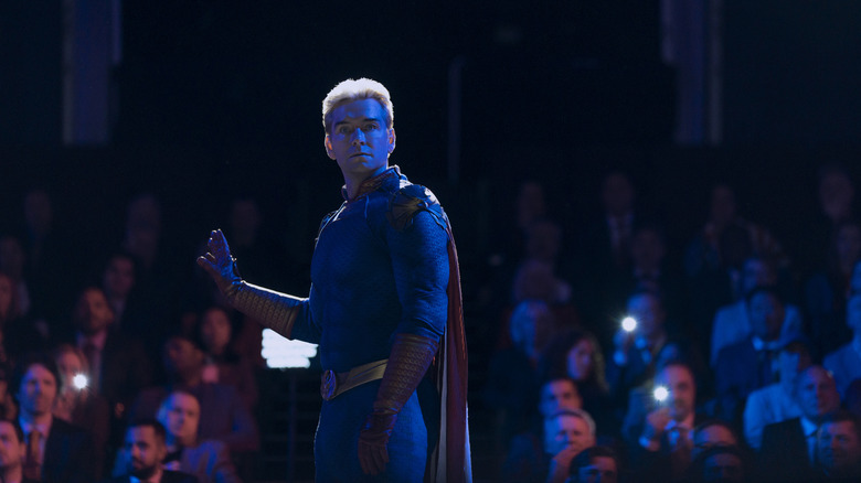 Homelander looks surprised while surrounded by a crowd in The Boys