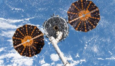 Northrop Grumman's Cygnus XL cargo spacecraft, with its two prominent cymbal-shaped UltraFlex solar arrays, is in the grasp of the Canadarm2 robotic arm before being released and departing the International Space Station to complete its resupply mission.