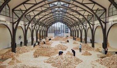 an installation of wooden blocks by Lina Lapelytė in a cavernous building