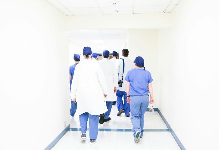 Medical staff walking down a hospital corridor, highlighting hidden truths about hospitals for those who dislike them.