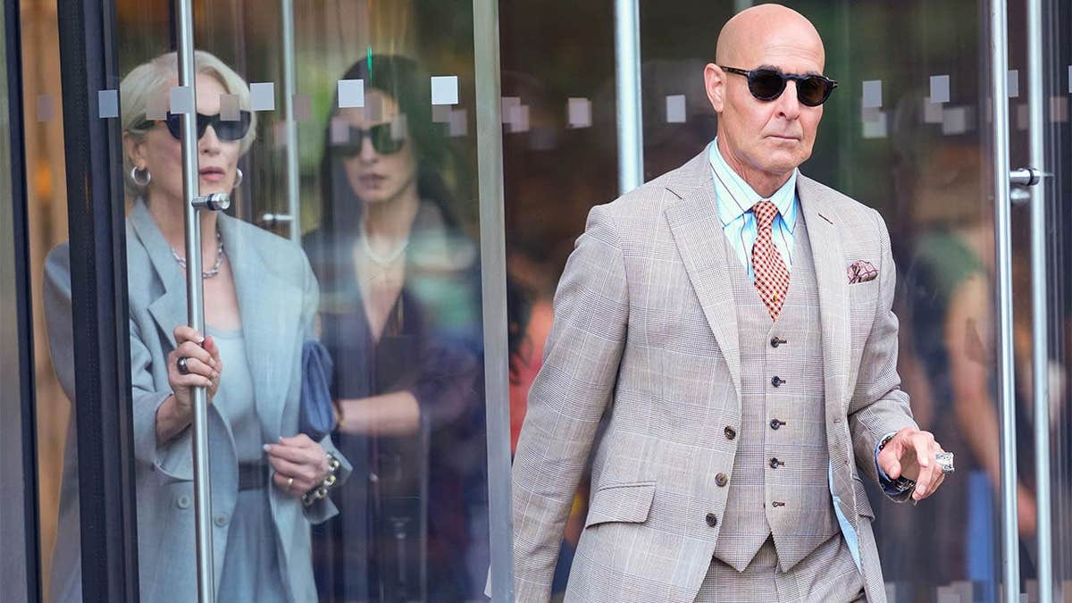 Meryl Streep, Anne Hathaway and Stanley Tucci standing on a film set in New York City