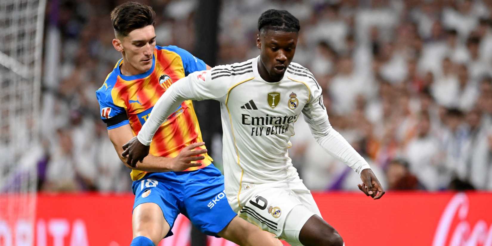 Real Madrid's Eduardo Camavinga holds off Valencia's Pepelu.
