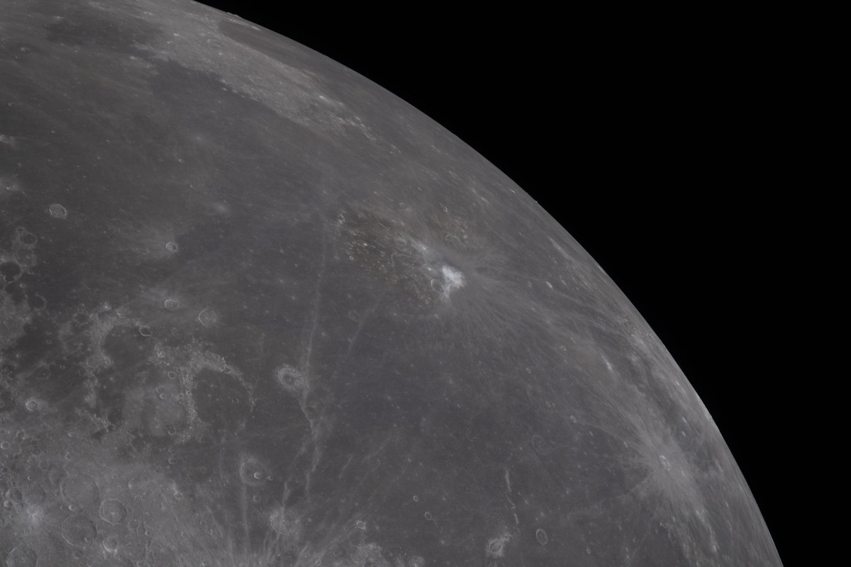 A picture of the moon's surface with bright circles representing craters and dark patches representing ancient lava.