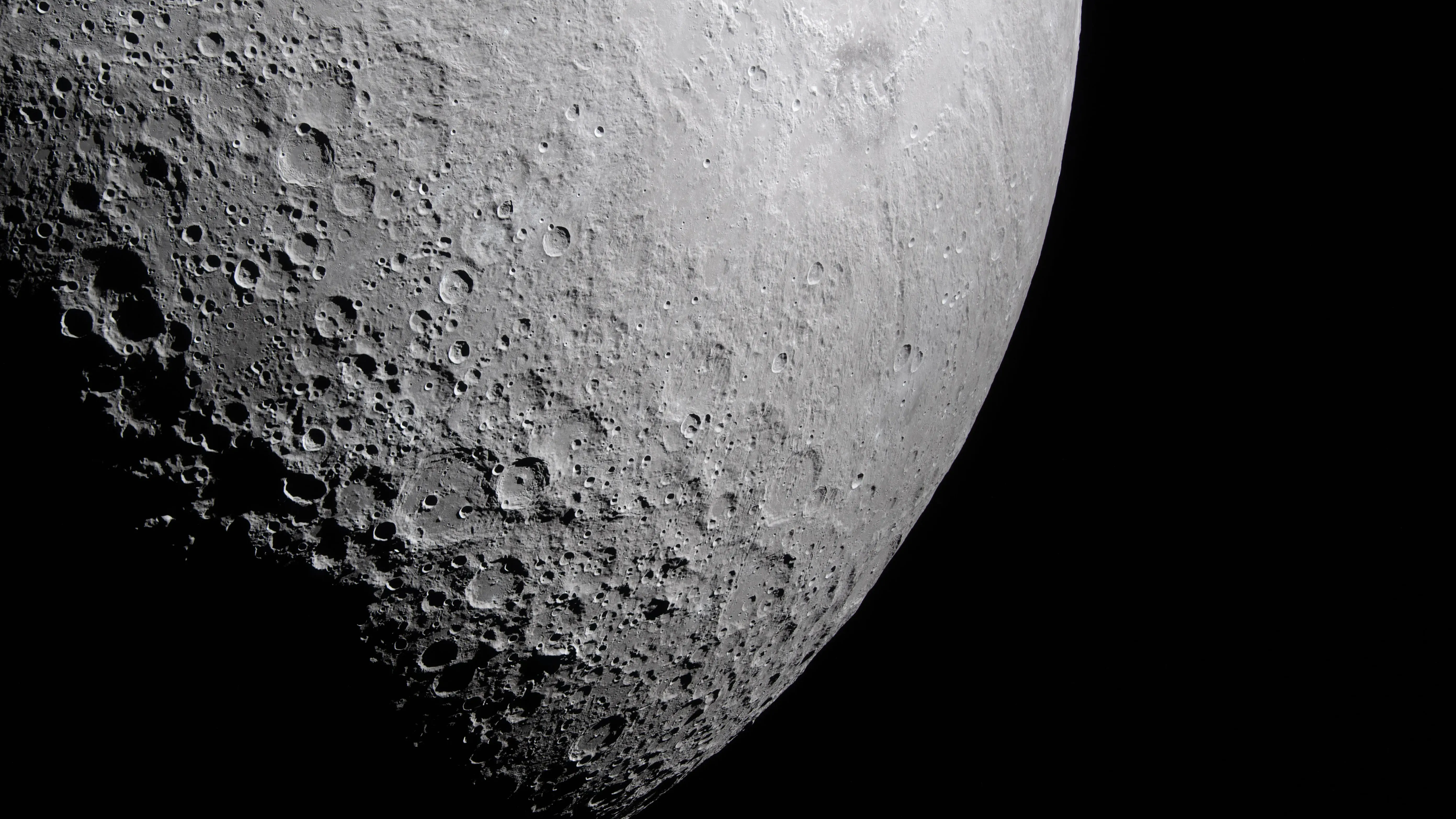 A photograph of the moon, showing a portion of its far side against a black space background.