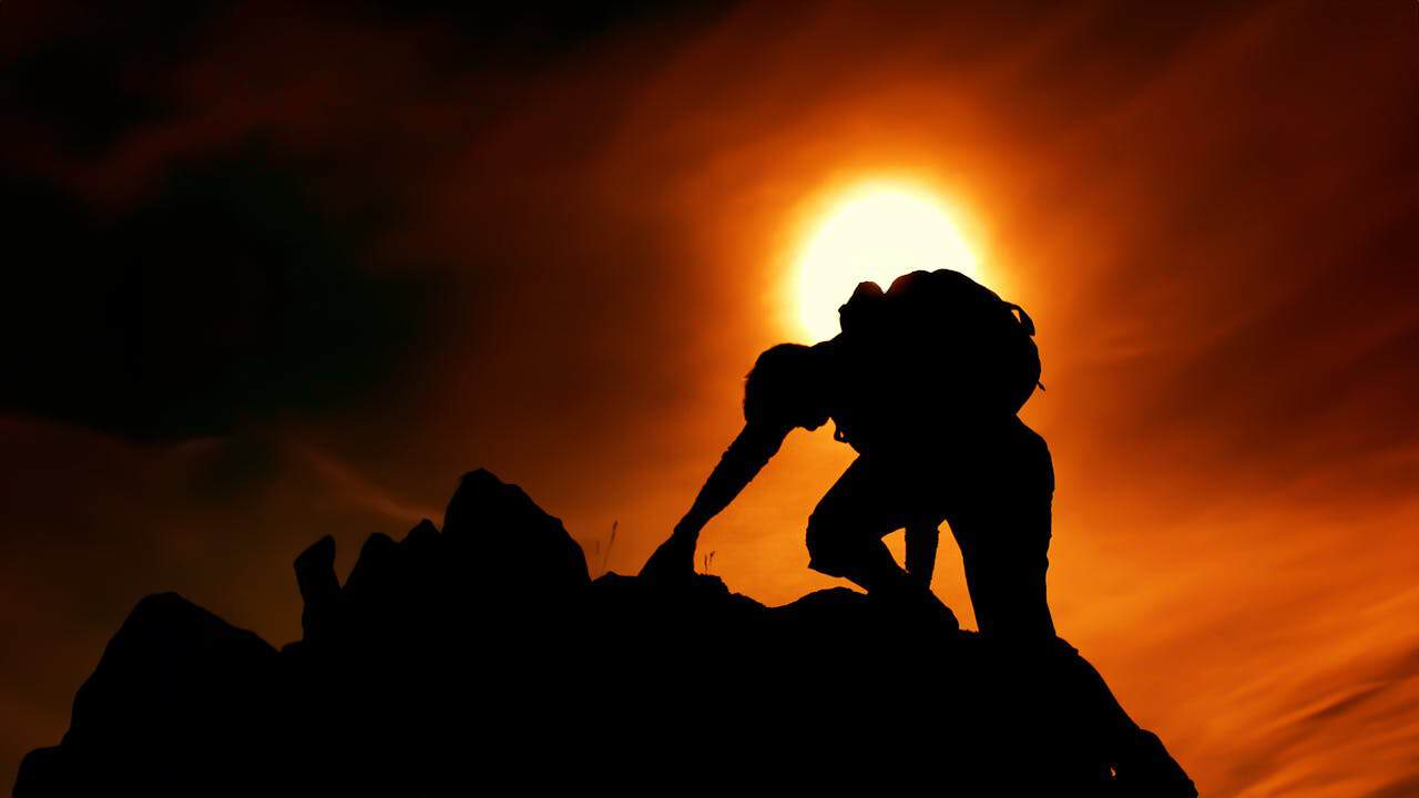 Photo by stein egil liland: https://www.pexels.com/photo/sun-over-silhouette-of-man-rock-climbing-20040806/