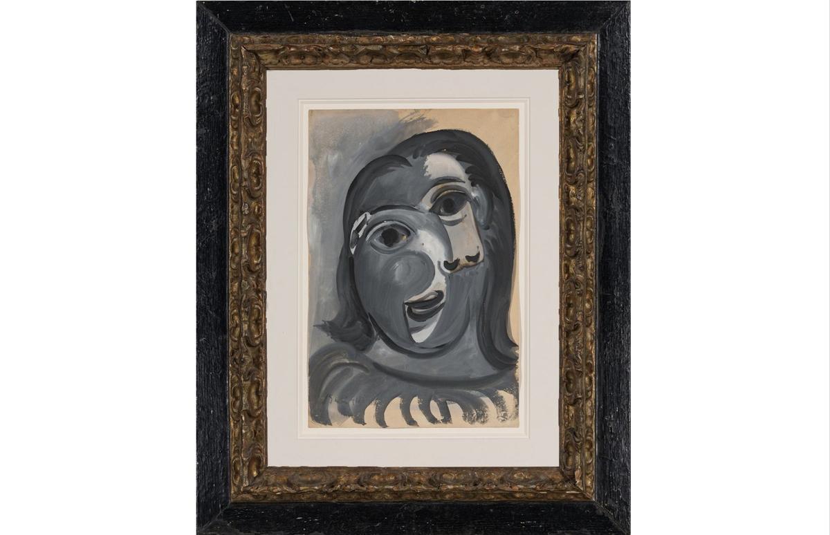 A picture of the framed Picasso painting, Tête de femme ( "Head of a Woman"), a very cubist portrait of a woman