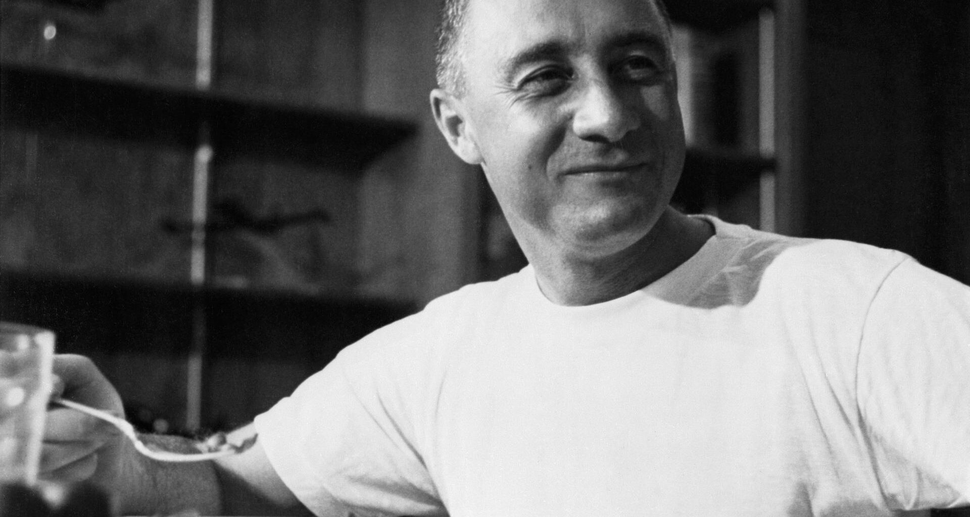 Grissom wears a t-shirt while eating a meal after his Mercury-Redstone 4 flight.