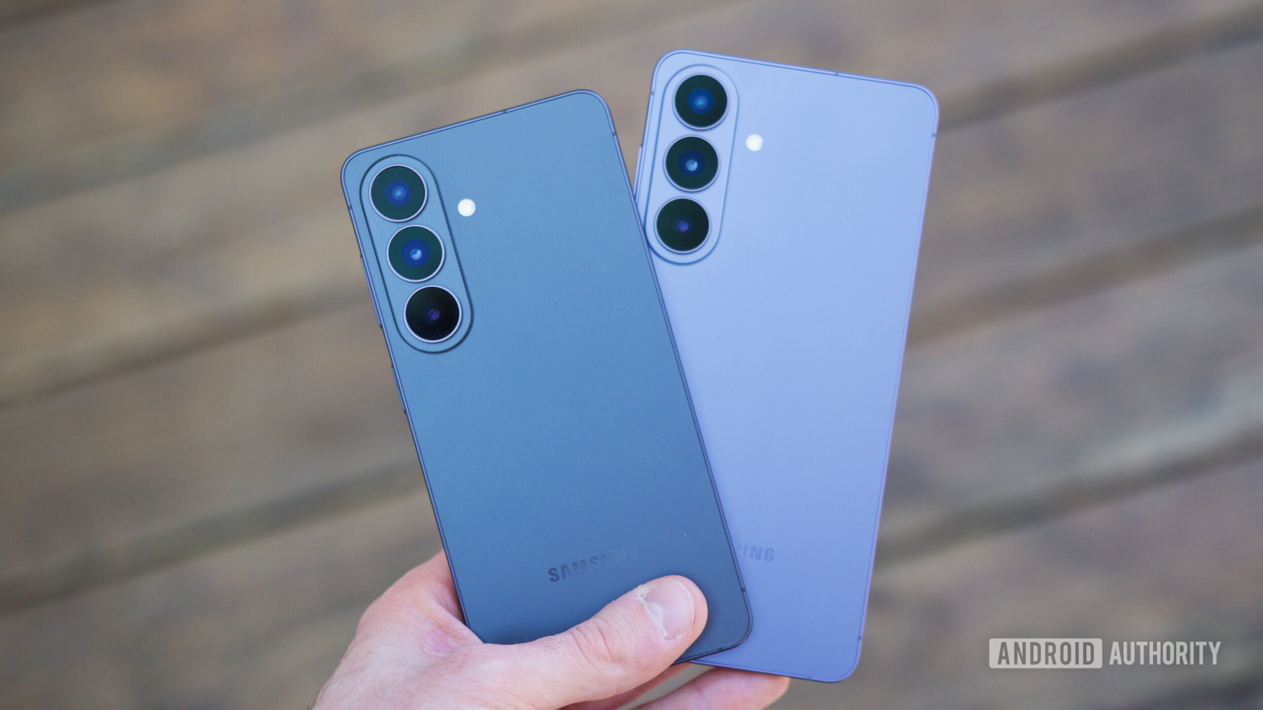 Someone holding the Samsung Galaxy S26 and Galaxy S26 Plus.