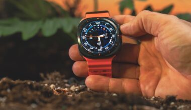 Samsung Galaxy Watch Ultra is held in a hand with the display facing forward.