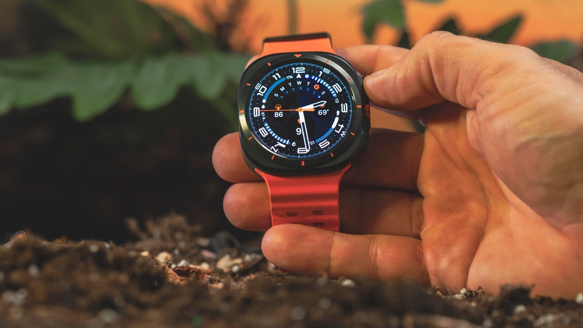 Samsung Galaxy Watch Ultra is held in a hand with the display facing forward.
