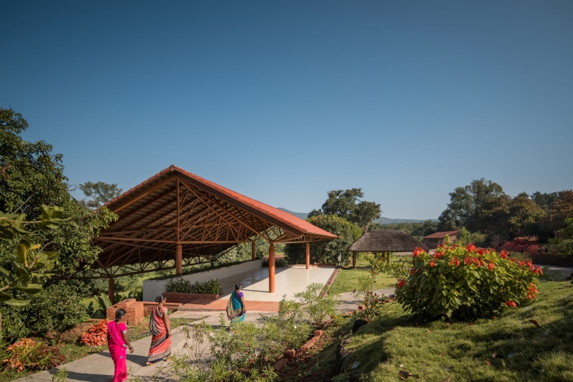 gabled roof floats over gathering pavilion’s brick stepped plinths in india - 3