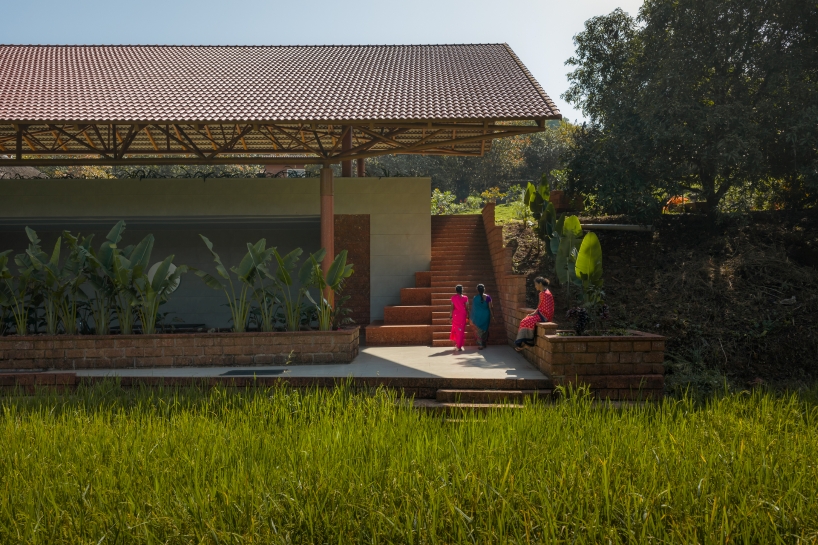 gabled roof floats over gathering pavilion’s brick stepped plinths in india - 4