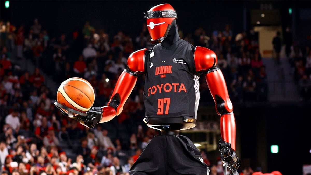 A humanoid robot in a Toyota jersey holds a basketball.