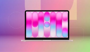 Pink MacBook Neo against purple, pink and green CNET background