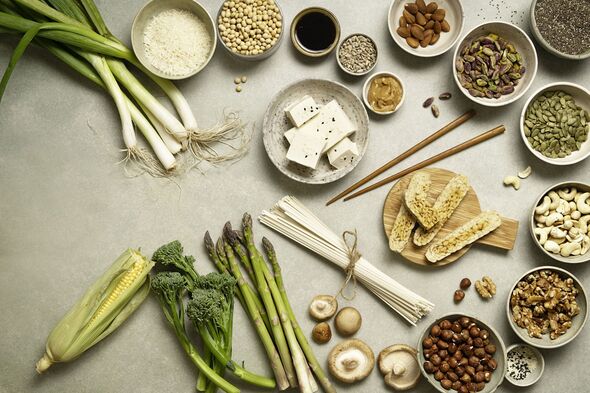various types of protein sources and plant based food on table with vegetables, spring onions, broccolini, asparagus various types of protein sources and plant based food on table with vegetables, spring onions, broccolini, asparagus