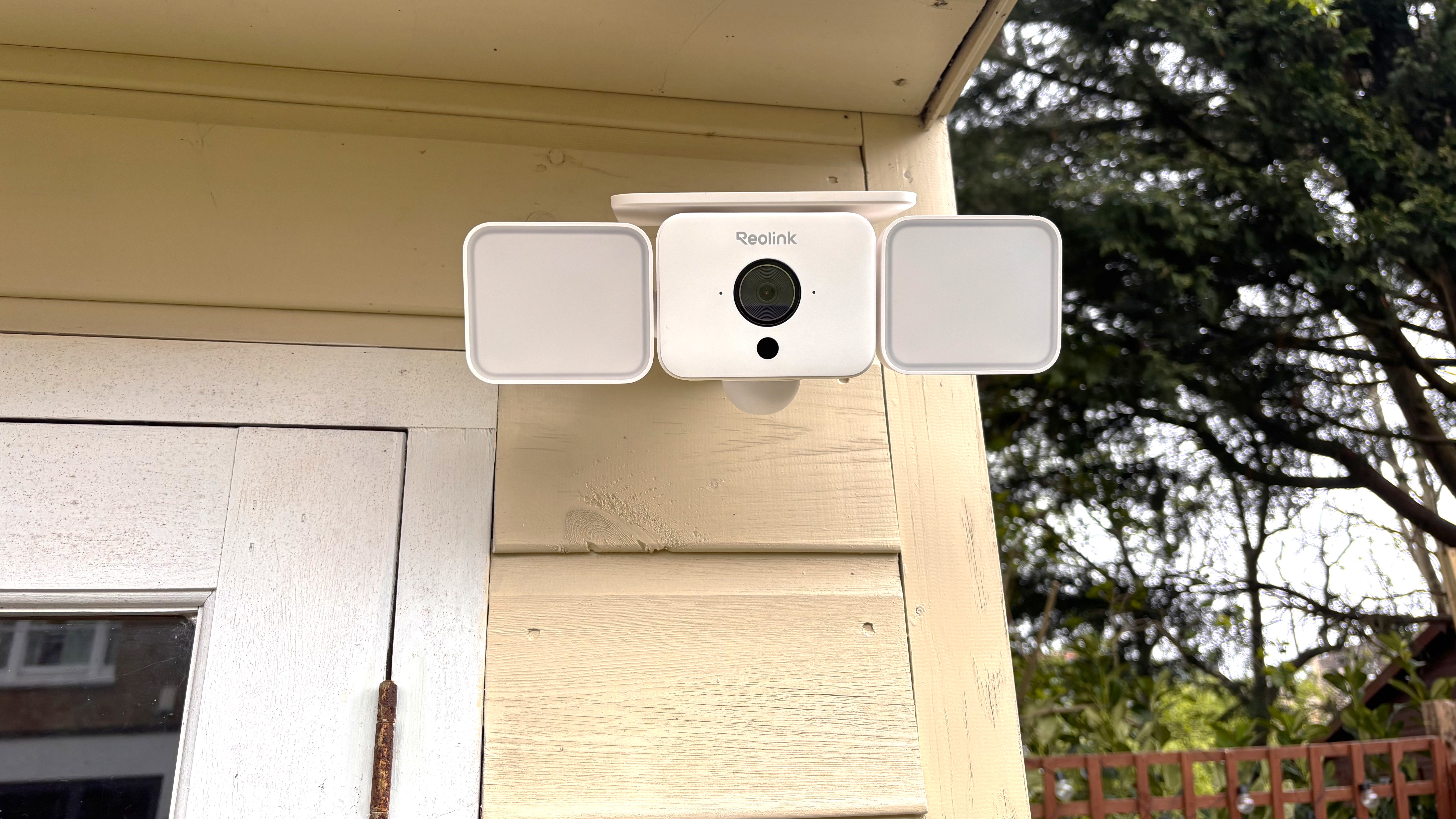 Reolink Solar Floodlight Cam mounted on wall, seen from below