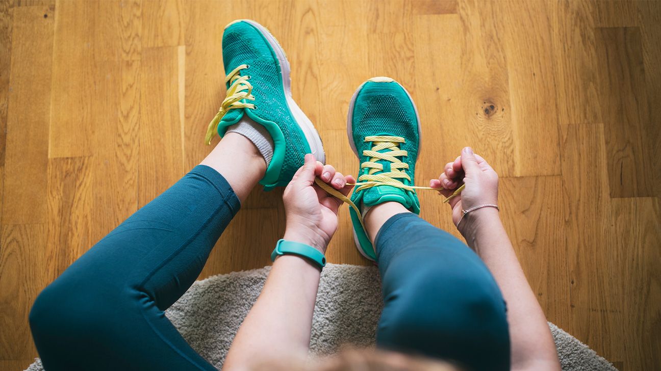 Female tying running shoes