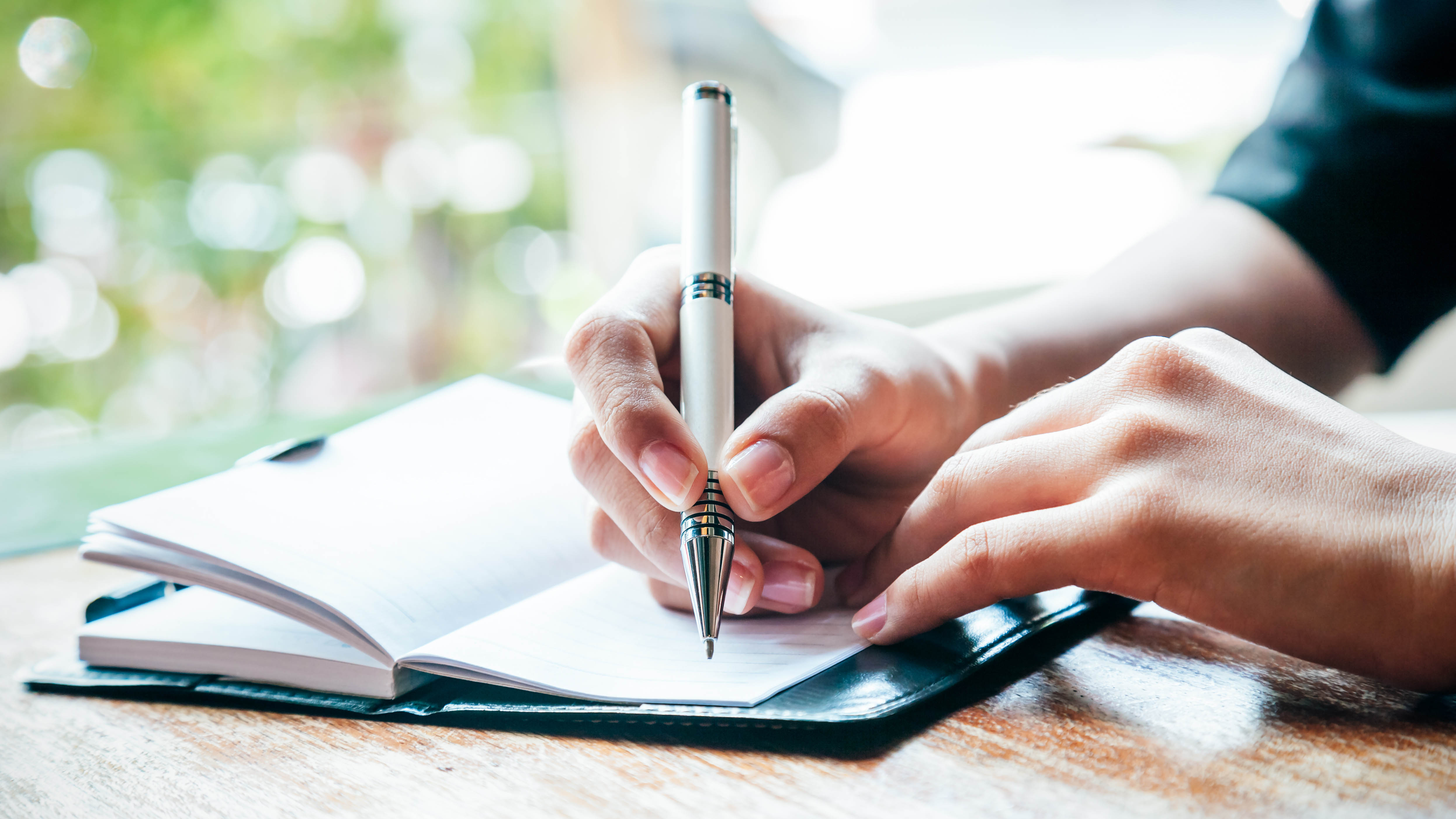 Someone writing in a journal