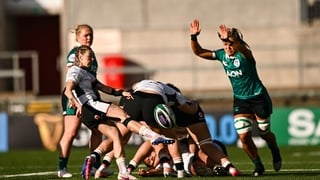 Keira Bevan of Wales has a kick chased down by Erin King of Ireland during the Women's 6 Nations Rugby Championship match between Ireland and Wales at Affidea Stadium in Belfast.