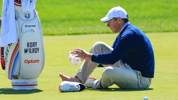 NEWTOWN, PENNSYLVANIA - MAY 12: Rory McIlroy of Northern Ireland attends to a blister on his right foot on the third hole during his practice round prior to the PGA Championship at Aronimink Golf Club on May 12, 2026 in Newtown, Pennsylvania. (Photo by David Cannon/Getty Images)