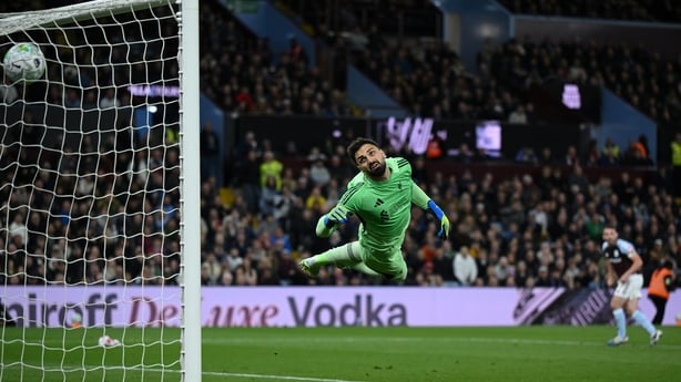 Giorgi Mamardashvili of Liverpool dives in vain as John McGinn of Aston Villa scores his team's fourth goal during the Premier League match between Aston Villa and Liverpool at Villa Park on May 15, 2026 in Birmingham, England. 