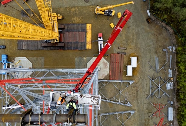 Aerial view taken on May 13, 2026 shows construction workers 100 meters up as they put together what will become the world's tallest wind turbine in Schipkau, eastern Germany