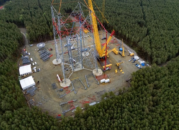 Aerial view taken on May 13, 2026 shows construction workers 100 meters up as they put together what will become the world's tallest wind turbine in Schipkau, eastern Germany