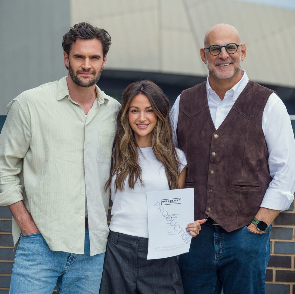 three individuals standing together outdoors holding a production document three individuals standing together outdoors holding a production document