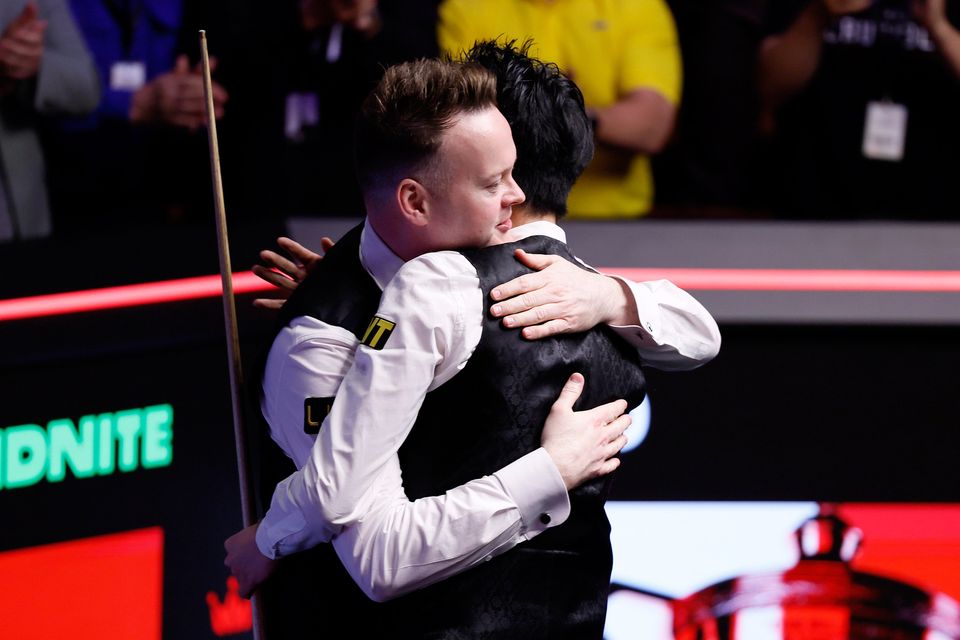 Wu Yize (right) celebrates winning the World Snooker Championship final against Shaun Murphy (left) at the Crucible. Photo: Richard Sellers/PA Wire.