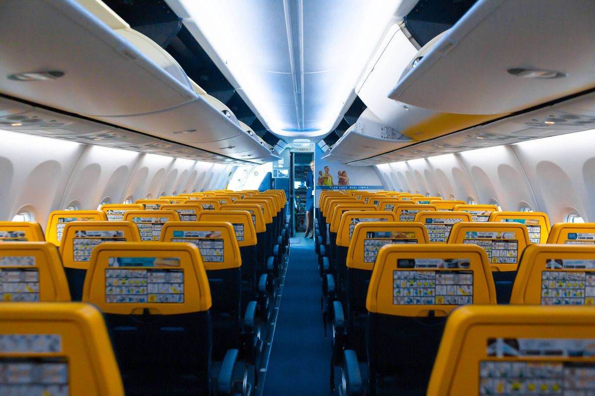Deserted aircraft cabin. Rows of seats without passengers