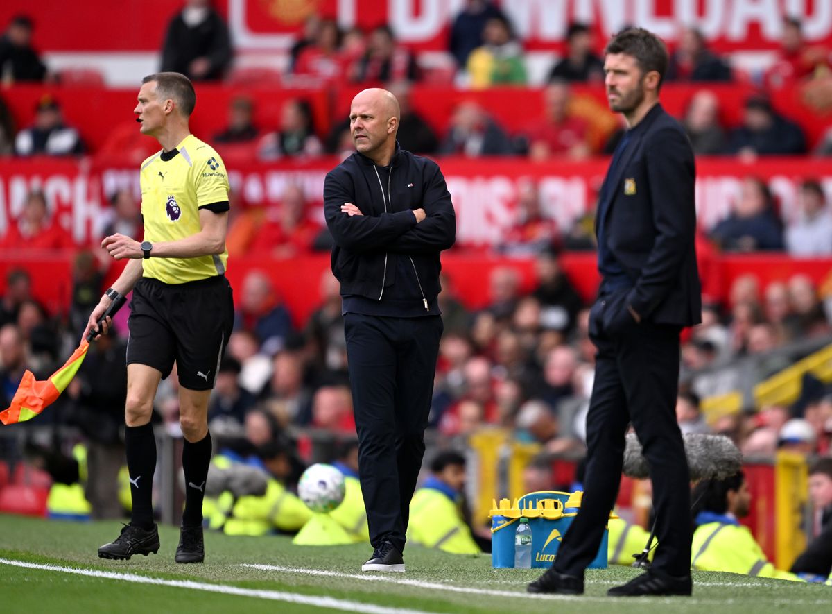 Arne Slot, head coach of Liverpool, and Michael Carrick, interim manager of Manchester United.