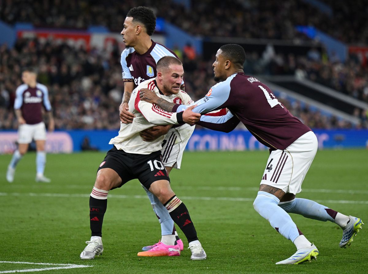 BIRMINGHAM, ENGLAND - MAY 15: Ezri Konsa of Aston Villa has his shirt ripped as he battles for position with Alexis Mac Allister of Liverpool during the Premier League match between Aston Villa and Liverpool at Villa Park on May 15, 2026 in Birmingham, England. (Photo by Shaun Botterill/Getty Images)