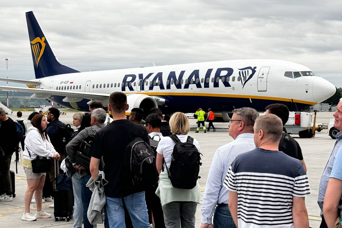 Queue of people board plane