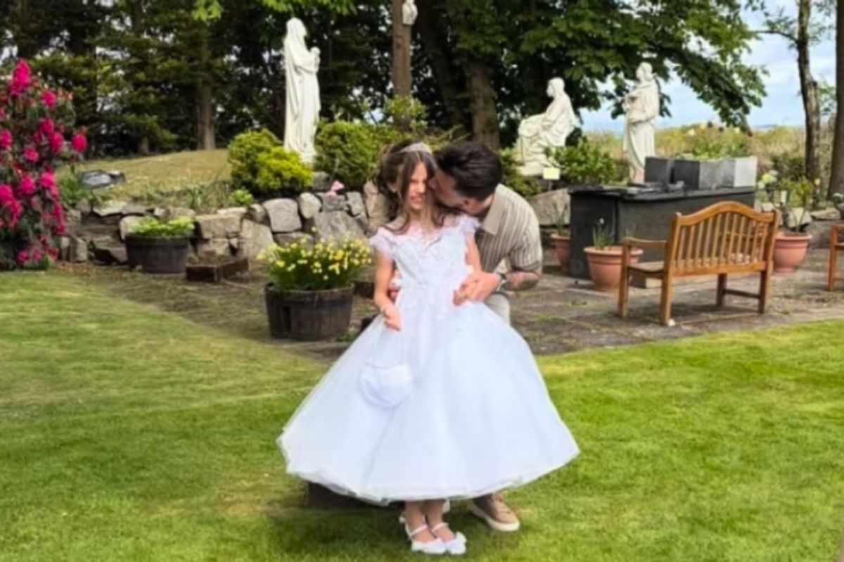 Graham Carey with his daughter Marlowe as she celebrates making her First Holy Communion