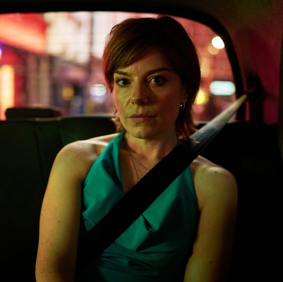 individual seated in a taxi with vibrant streetlights visible outside individual seated in a taxi with vibrant streetlights visible outside