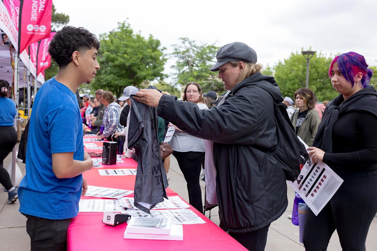 Gina Rodriguez, a fan of BTS for a decade, picks out the merchandise she wants after becoming the first in line to buy merchandise Friday, May 1, 2026, outside the Don Haskins Center in El Paso, Texas. Rodriguez said she had been in line since 3:30 a.m., a day before the band’s first concert.