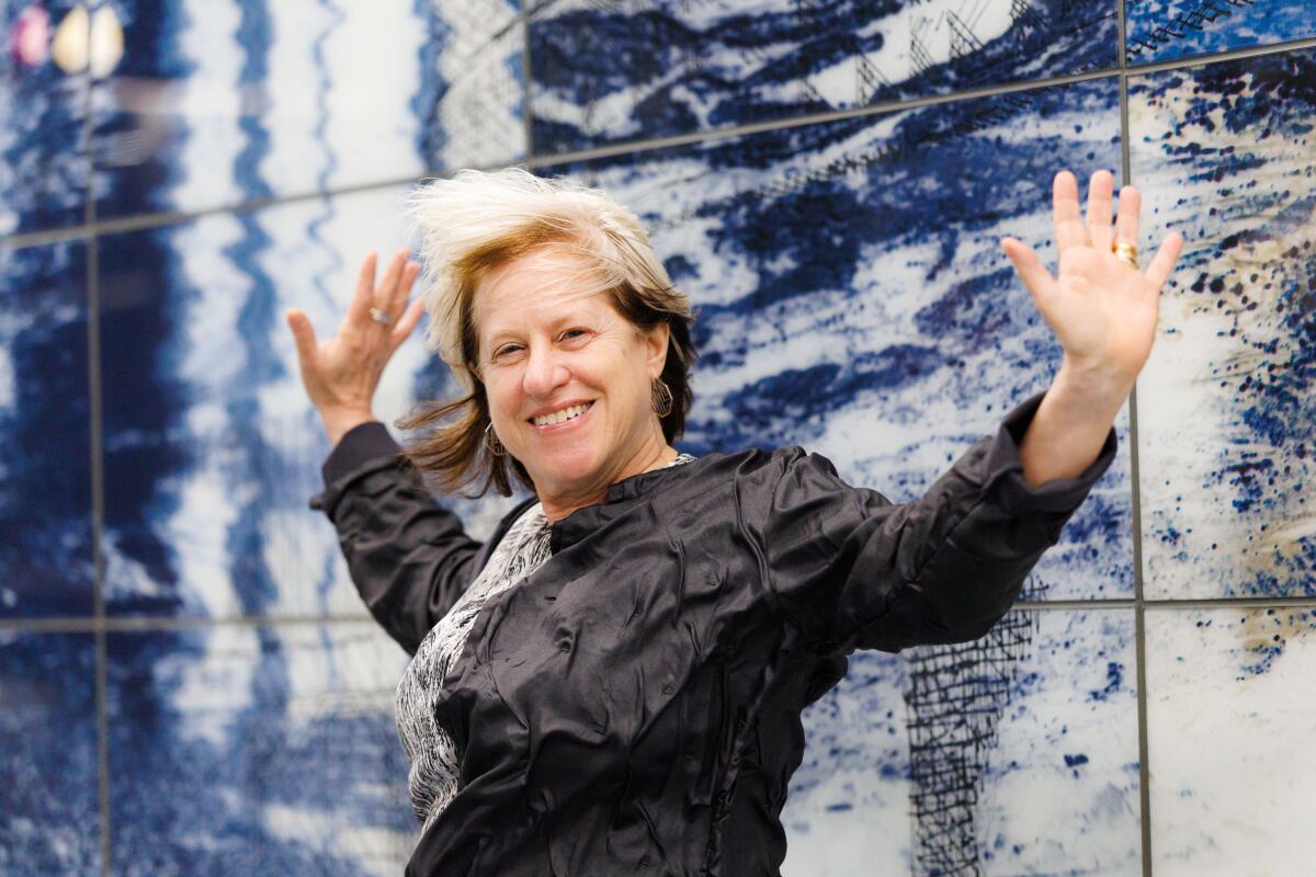  Artist Fran Siegel stands in front of her artwork at the Wilshire/La Brea Metro Station 