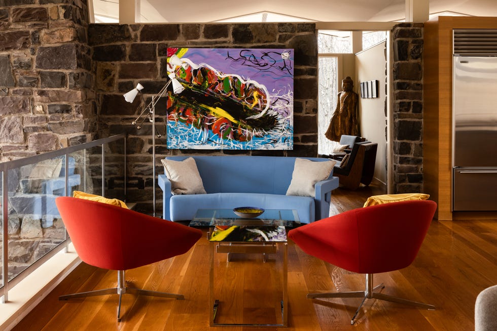 Modern living room with colorful furniture and artwork.