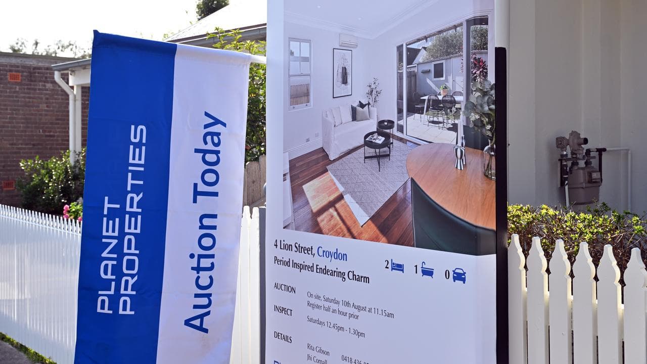 Signs and flags on a house before a auction (file image)