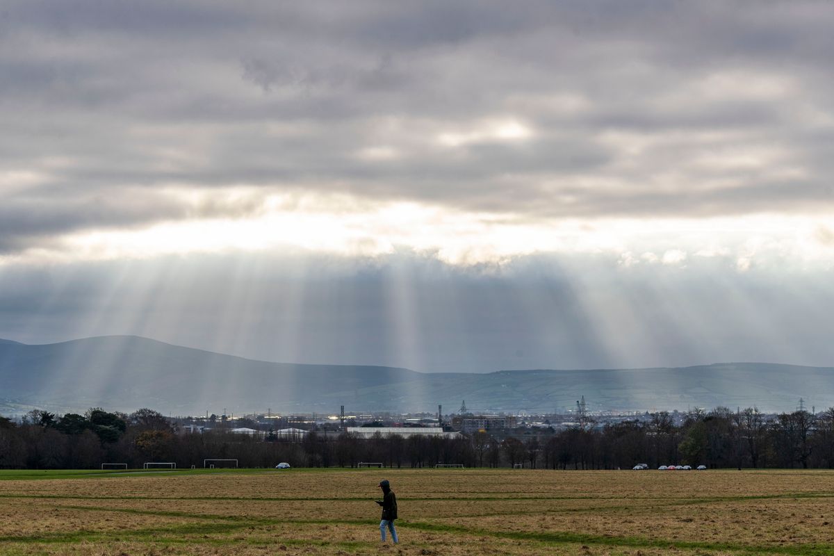 Shafts of light pierce through the afternoon cloud in the Phoenix Park
