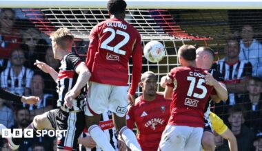 Salford defender Adebola Oluwo heads towards goal