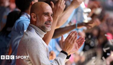 Manager Pep Guardiola applauds as his Manchester City players lift the FA Cup trophy after beating Chelsea in the 2026 final