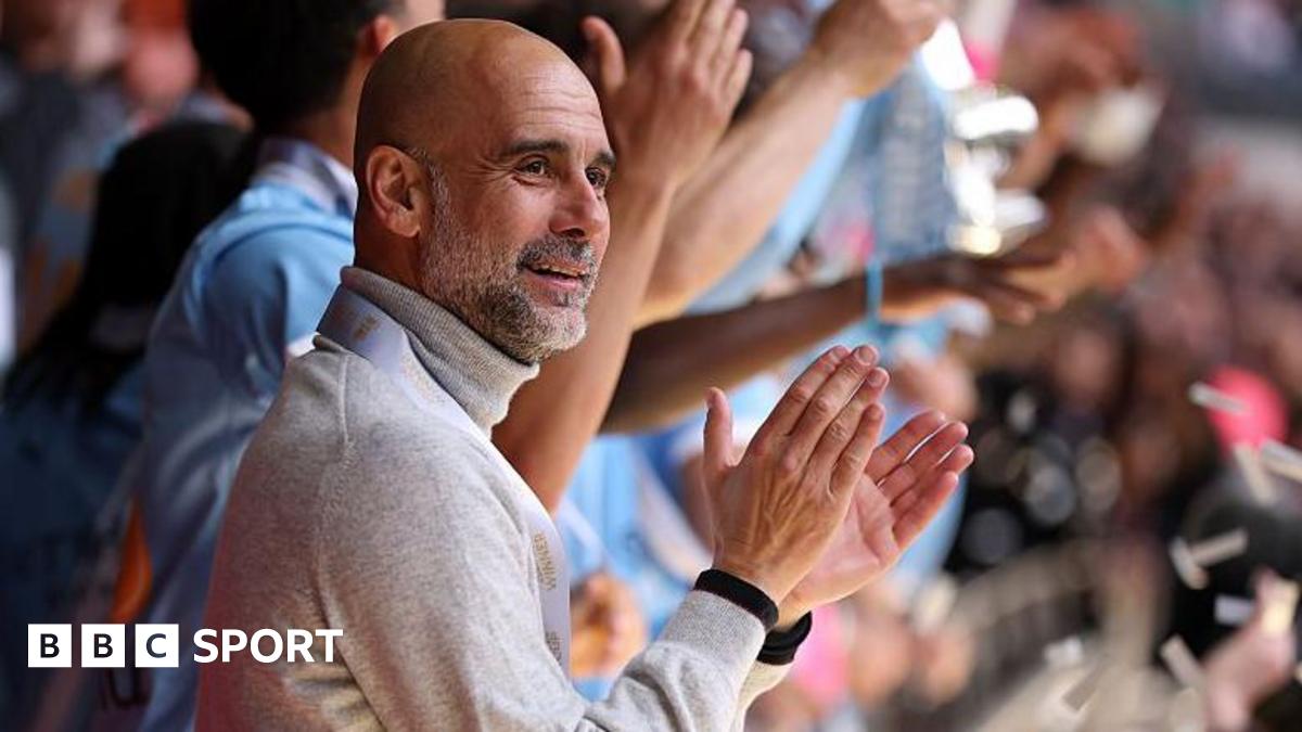 Manager Pep Guardiola applauds as his Manchester City players lift the FA Cup trophy after beating Chelsea in the 2026 final