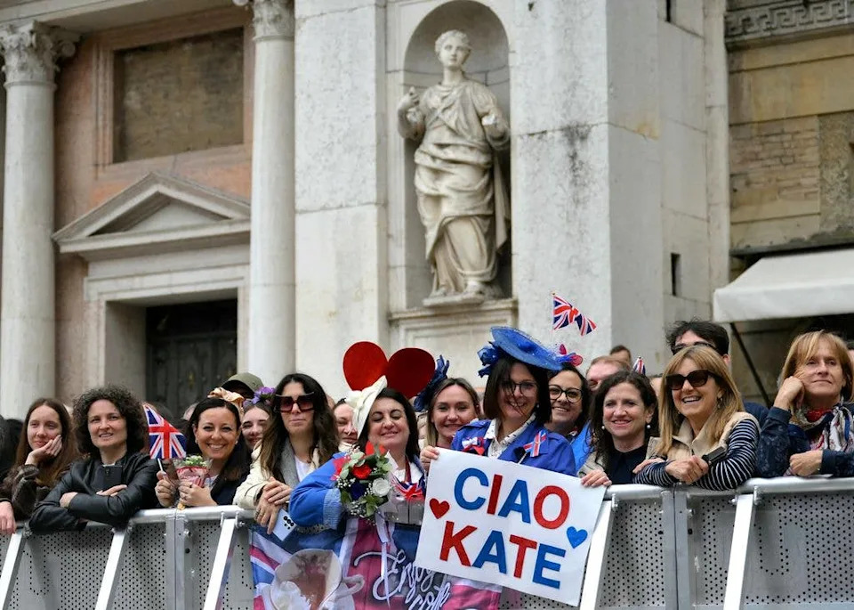 People wait for the arrival of Britain's Catherine, Princess of Wales in front of Reggio Emilia  Town Hall, as part of a two-day trip in Italy, on May 13, 2026