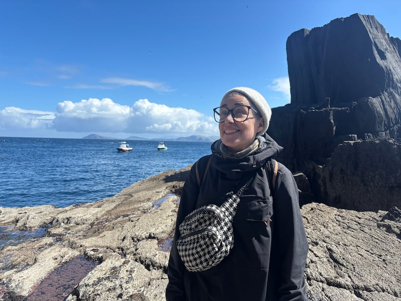 Lucy Karanfilian from New York awaiting her boat at the east pier on Skellig Michael. Photo: Simon Carswell