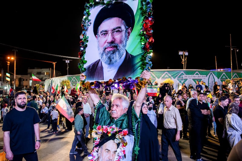 A man holds a photo of Mojtaba Khamenei, Iran’s new supreme leader, during a ceremony for the national soccer team in Tehran. Photograph: Arash Khamooshi/Polaris for The New York Times