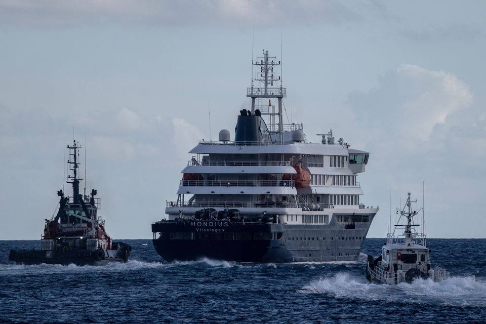 Port vessels accompany the MV Hondius as it departs the Granadilla Port after all passengers were evacuated on May 11, 2026 in Tenerife. Photo: Getty Images