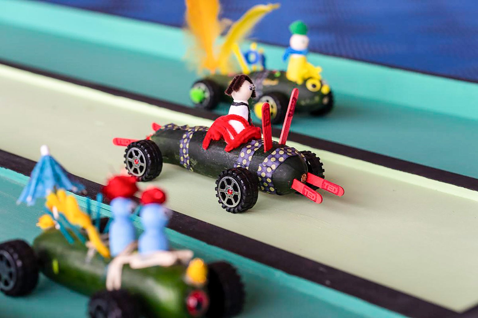 Little card made from zucchinis with wheels, people, etc. that look similar to LEGOs.